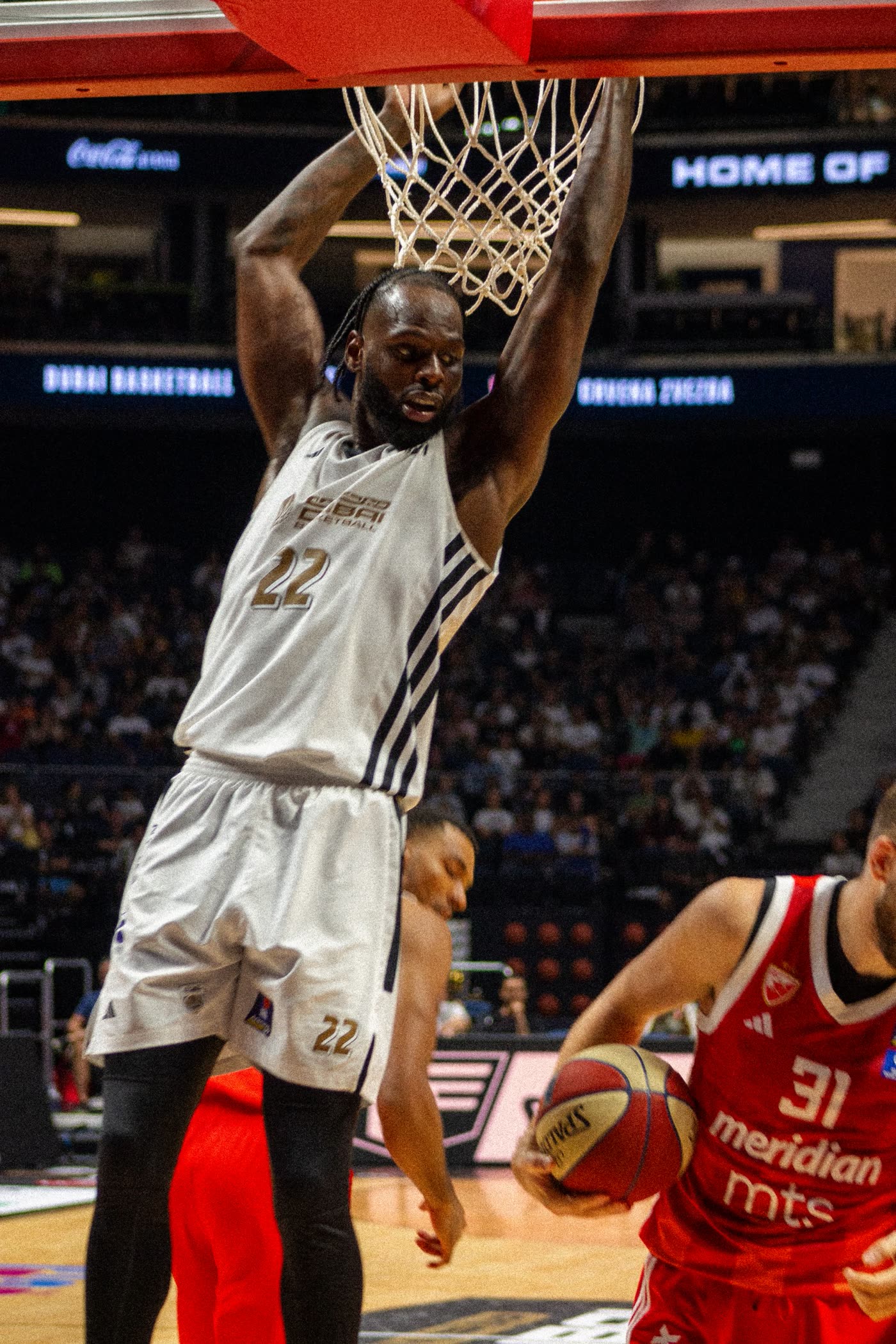 Dubai Basketball number 22 hanging on the rim after a dunk