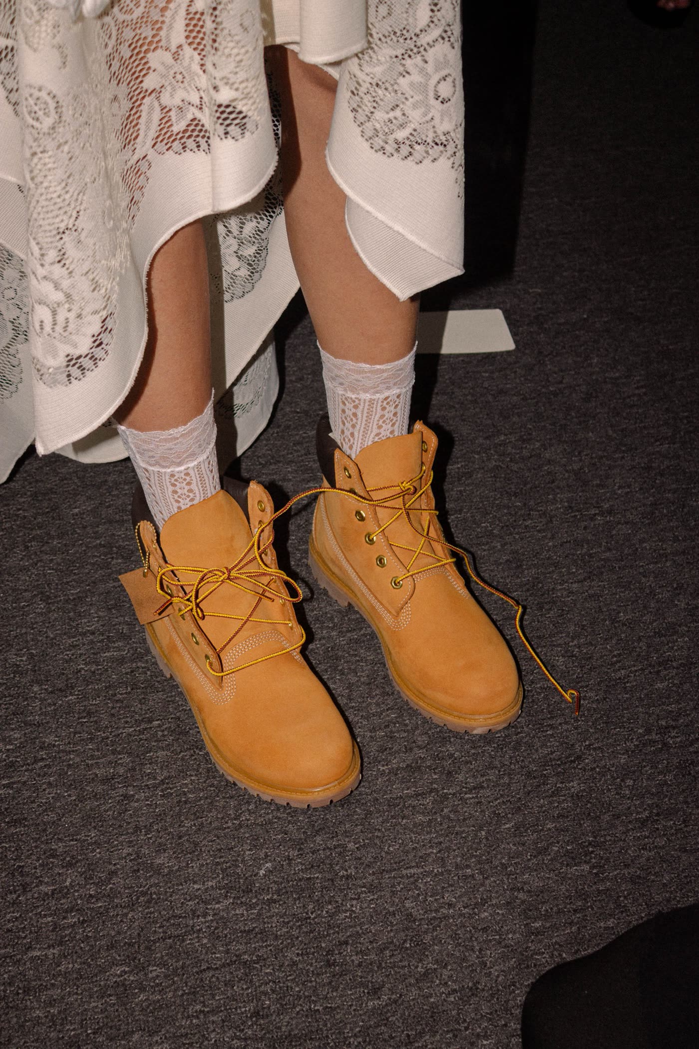 Lace socks and Timberland boots under a lace hem