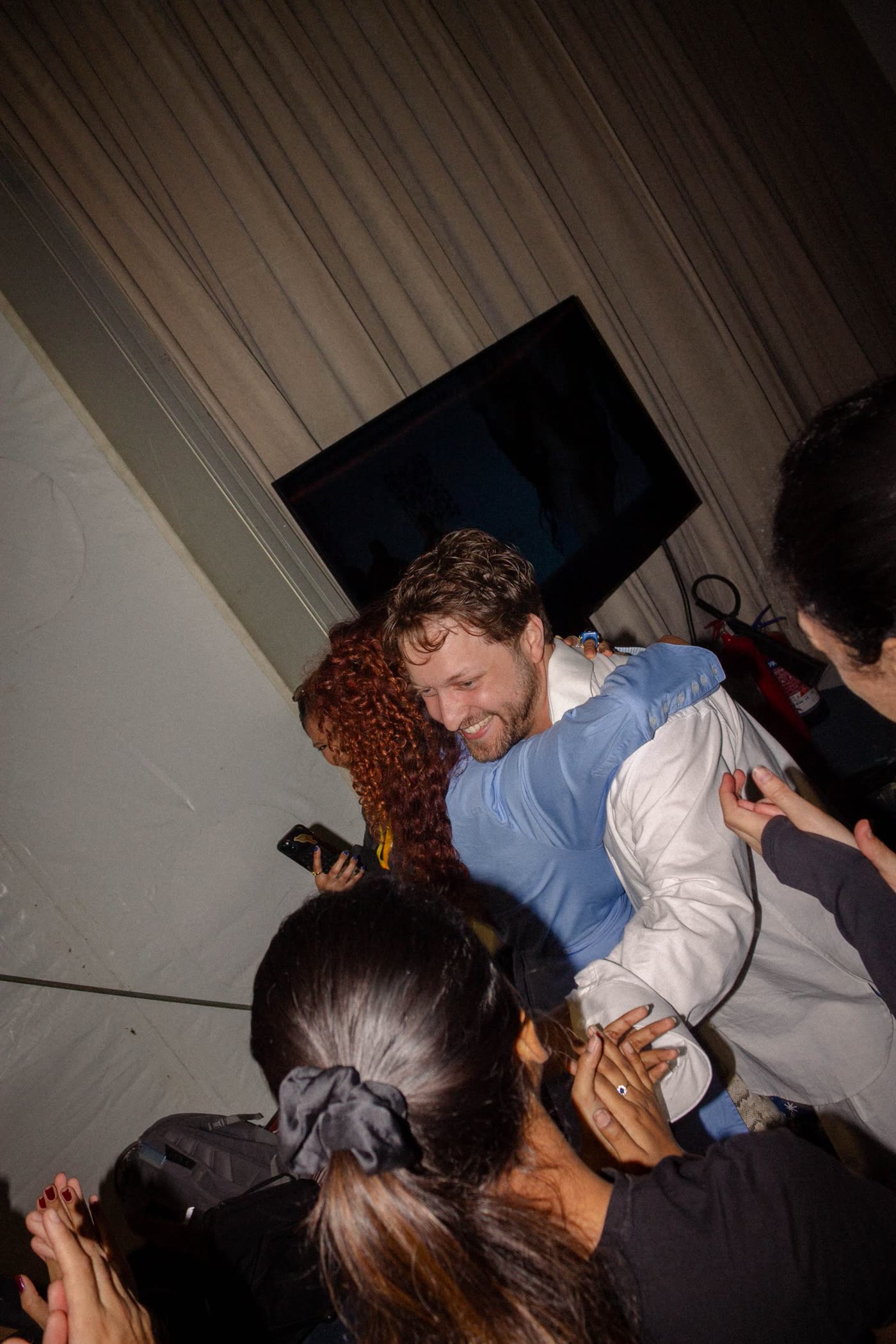 The designer hugging the team after the show