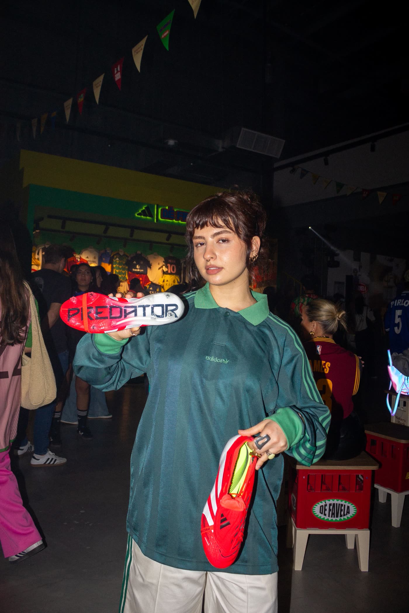 Guest in a green adidas shirt showing the Predator sole