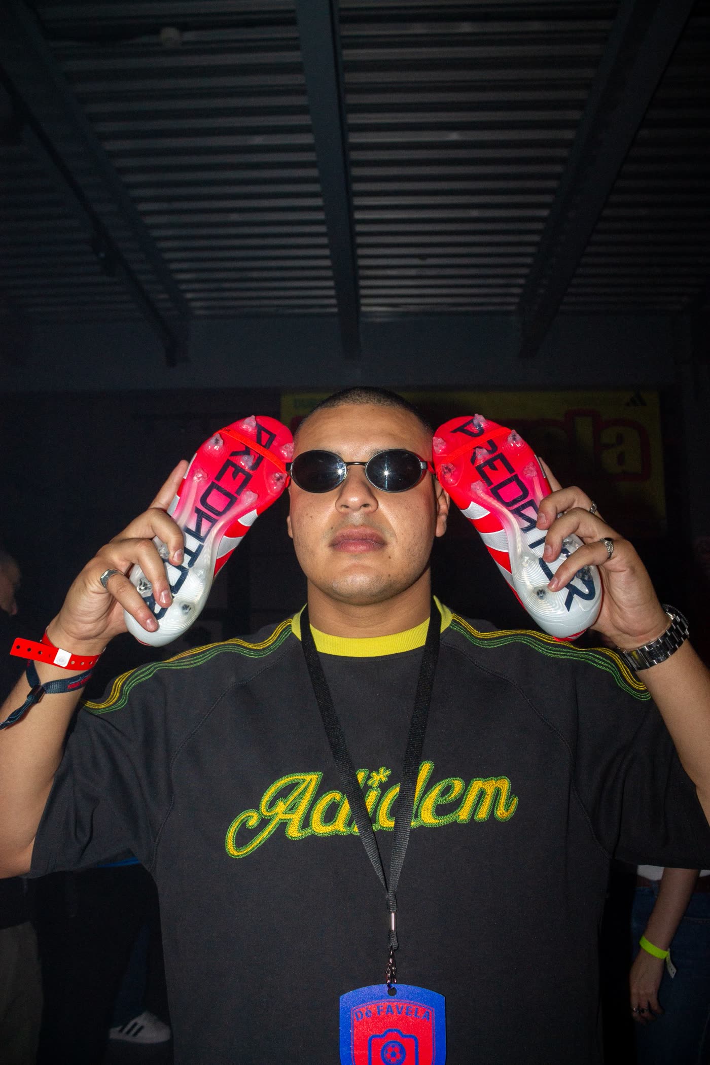 Guest in sunglasses holding two Predator boots either side of his head