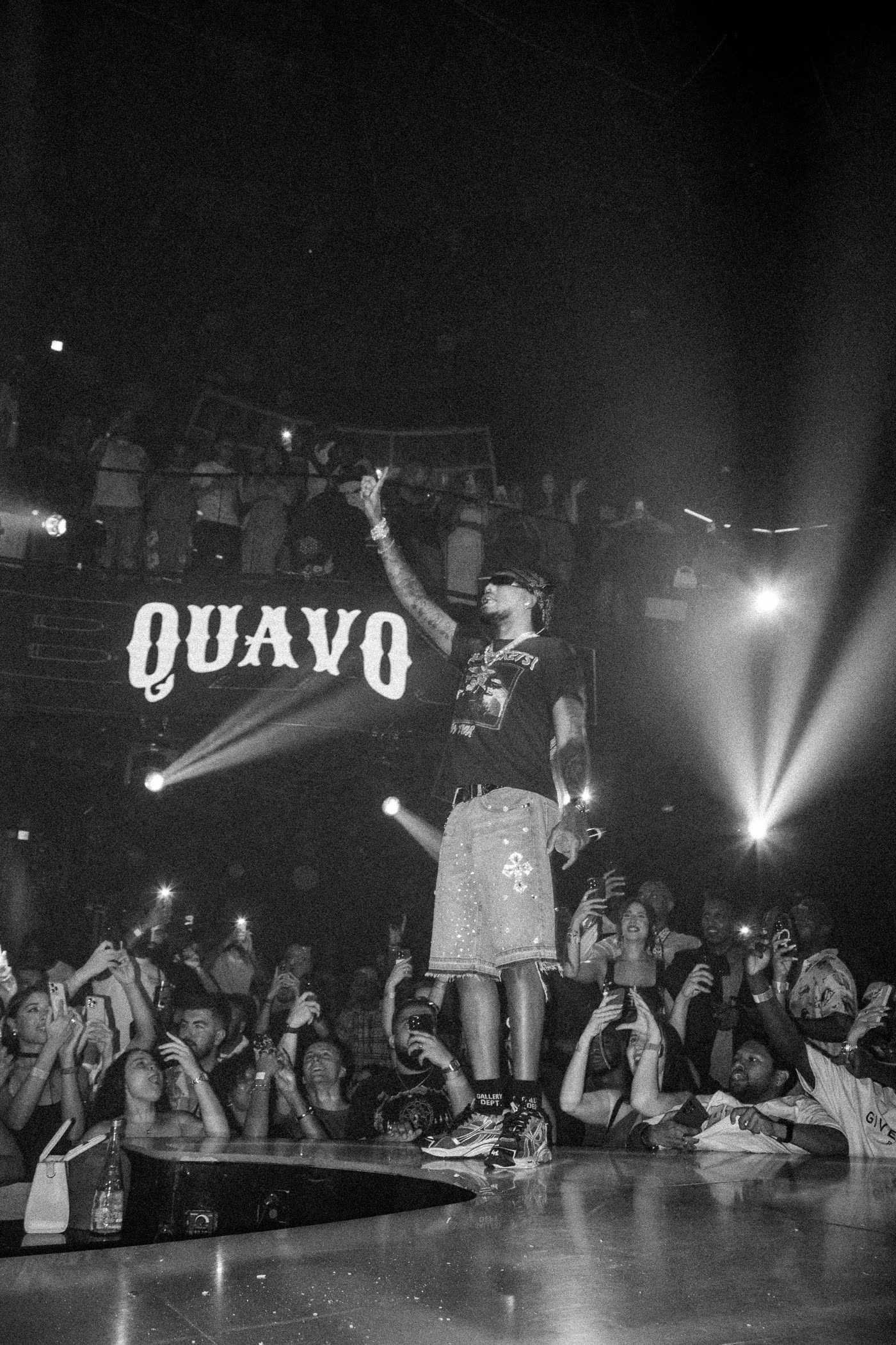 Quavo performing, black and white